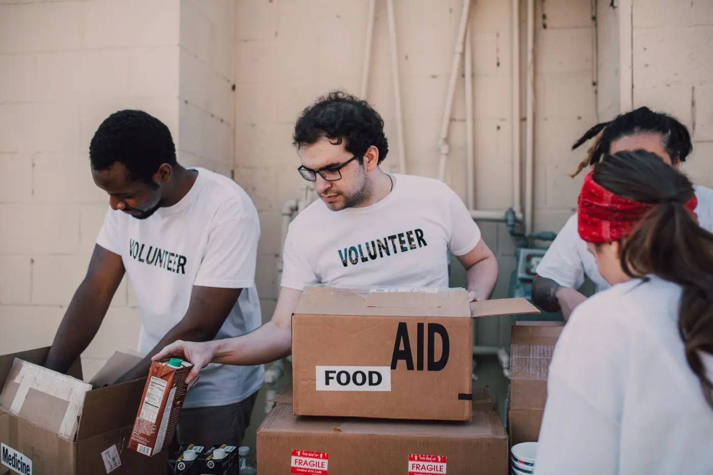 Volunteers packing food and aid boxes outdoors